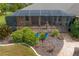 Aerial shot of the covered patio, complemented by well-maintained landscaping, ideal for outdoor relaxation and entertainment at 19815 Sea Rider Way, Lutz, FL 33559