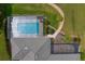 Overhead view of a screened pool area with patio seating and landscaped surroundings at 19815 Sea Rider Way, Lutz, FL 33559