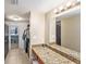 Bathroom area featuring granite countertop, mirror, and view into bedroom at 200 Country Club Dr # 403, Largo, FL 33771