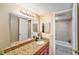 Bathroom featuring granite countertops, a large mirror, and a shower/tub combination at 200 Country Club Dr # 403, Largo, FL 33771