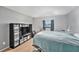 Bright bedroom with a window, black shelving unit, and a cozy area for a pet at 200 Country Club Dr # 403, Largo, FL 33771