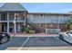 Two-story condo building with blue siding, brick accents, and accessible parking at 200 Country Club Dr # 403, Largo, FL 33771