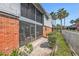 Back of building featuring screened in porches and fenced in yards at 200 Country Club Dr # 403, Largo, FL 33771