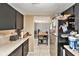 Efficient kitchen with black cabinets, tile floor, stainless steel refrigerator and open access to the dining area at 200 Country Club Dr # 403, Largo, FL 33771