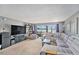 Bright living area with a gray sofa, entertainment center, and sliding doors leading to a patio at 200 Country Club Dr # 403, Largo, FL 33771