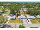 Aerial view of a charming neighborhood showcasing the home's location and proximity to lush green spaces at 2004 Yale Ave, Dunedin, FL 34698