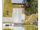 Aerial shot showcasing the home's layout, backyard patio, and spacious driveway at 2004 Yale Ave, Dunedin, FL 34698