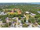 Aerial view of a residential neighborhood with nearby sports fields and wooded areas at 2004 Yale Ave, Dunedin, FL 34698