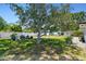 Backyard featuring mature trees, a storage shed, privacy fencing, and a serene outdoor space at 2004 Yale Ave, Dunedin, FL 34698