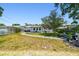 Spacious backyard with a stone pathway, lush greenery, and a serene outdoor setting perfect for relaxation at 2004 Yale Ave, Dunedin, FL 34698