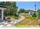 Expansive backyard featuring a stone pathway, well-maintained lawn, and mature trees for added privacy at 2004 Yale Ave, Dunedin, FL 34698