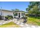 Inviting backyard with stone pathway, outdoor grilling area, and a tranquil space for relaxation and entertainment at 2004 Yale Ave, Dunedin, FL 34698