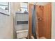 Cozy bathroom featuring tiled shower, cabinet, and toilet at 2004 Yale Ave, Dunedin, FL 34698