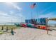 Scenic beach scene with colorful kayaks on the sand and an American flag waving at 2004 Yale Ave, Dunedin, FL 34698