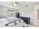 Neutral bedroom featuring two dressers, a window, and a ceiling fan at 2004 Yale Ave, Dunedin, FL 34698
