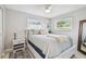 Comfortable bedroom with neutral tones, ample natural light and a ceiling fan at 2004 Yale Ave, Dunedin, FL 34698