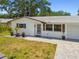 Lovely single-Gathering home with a brick walkway, manicured lawn, and charming curb appeal at 2004 Yale Ave, Dunedin, FL 34698