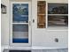Inviting front entrance featuring a screen door, stylish wood shutters, and a decorative heart wreath at 2004 Yale Ave, Dunedin, FL 34698