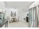 Open concept kitchen with stainless steel refrigerator and view of the dining area and living room at 2004 Yale Ave, Dunedin, FL 34698