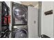 Modern laundry area with stacked washer and dryer, and ample storage space at 2004 Yale Ave, Dunedin, FL 34698