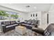 Modern living room features stylish sofas, a sleek console table, and ample natural light, creating a cozy atmosphere at 2004 Yale Ave, Dunedin, FL 34698
