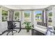 Sunroom with desk area and plenty of natural light with views to the backyard at 2004 Yale Ave, Dunedin, FL 34698