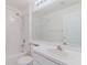This well-lit bathroom features neutral walls, with a vanity, mirror and shower-tub combination at 24839 Wild Frontier Dr, Land O Lakes, FL 34639