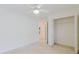 Bright bedroom featuring neutral walls, carpet flooring, and a ceiling fan for added comfort at 24839 Wild Frontier Dr, Land O Lakes, FL 34639