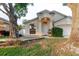 Inviting home with an arched entry and a lush front yard with mature trees at 24839 Wild Frontier Dr, Land O Lakes, FL 34639
