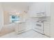 Bright kitchen with white cabinets, modern appliances, and open layout into the living area at 24839 Wild Frontier Dr, Land O Lakes, FL 34639
