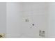 This well-lit laundry room features neutral walls, with a tile floor, and wire shelving at 24839 Wild Frontier Dr, Land O Lakes, FL 34639