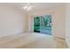 Open living room featuring sliding glass doors to the backyard and built-in shelving at 24839 Wild Frontier Dr, Land O Lakes, FL 34639
