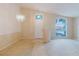 Large, light-filled living space featuring high ceilings and a front door view at 24839 Wild Frontier Dr, Land O Lakes, FL 34639