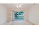Living room featuring built-in shelving and sliding glass doors to the patio at 24839 Wild Frontier Dr, Land O Lakes, FL 34639