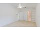 Bright primary bedroom featuring neutral walls, carpet flooring, and a ceiling fan for added comfort at 24839 Wild Frontier Dr, Land O Lakes, FL 34639