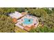 Aerial view of a community pool area with a clubhouse and lots of seating at 24839 Wild Frontier Dr, Land O Lakes, FL 34639