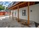 Back porch with neutral paint and wood columns offering ample outdoor space and access to the upper balcony at 2718 N 21St St, Tampa, FL 33605