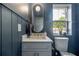 Charming bathroom features custom vanity, gold fixtures, and beadboard accent wall with view to the exterior at 2718 N 21St St, Tampa, FL 33605