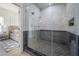 Luxurious shower featuring glass doors, dual shower heads, dark tile accents, and a convenient built-in shelf at 2718 N 21St St, Tampa, FL 33605