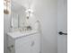Elegant powder room featuring white vanity with gold fixtures and a decorative mirror and lighting at 2718 N 21St St, Tampa, FL 33605