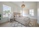 Bright bedroom featuring modern decor, a plush rug, and light wood floors, creating a serene and stylish space at 2718 N 21St St, Tampa, FL 33605