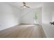 Bright bedroom features hardwood flooring, a ceiling fan, and a private entrance to the outdoor balcony at 2718 N 21St St, Tampa, FL 33605