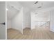 Bedroom with hardwood flooring, an open closet, and a doorway leading out to the common area at 2718 N 21St St, Tampa, FL 33605