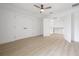 Spacious bedroom featuring hardwood flooring, a ceiling fan, and a doorway leading out to the common area at 2718 N 21St St, Tampa, FL 33605
