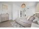 Bedroom showcasing a stylish dresser, a comfortable bed with decorative pillows, and light wood flooring at 2718 N 21St St, Tampa, FL 33605