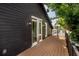 Large wooden deck on side of house with dark wood siding and black trim at 2718 N 21St St, Tampa, FL 33605