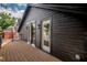 Large wooden deck on side of house with dark wood siding and black trim at 2718 N 21St St, Tampa, FL 33605