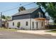 Exterior of a two-story home with a balcony and open patio, offering a blend of modern and traditional design at 2718 N 21St St, Tampa, FL 33605