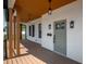 Charming front porch with wood columns, modern lighting fixtures, and a freshly painted exterior, creating a welcoming entrance at 2718 N 21St St, Tampa, FL 33605