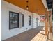 Inviting front porch featuring wood floors, contemporary lighting, and fresh white paint, perfect for relaxing outdoors at 2718 N 21St St, Tampa, FL 33605